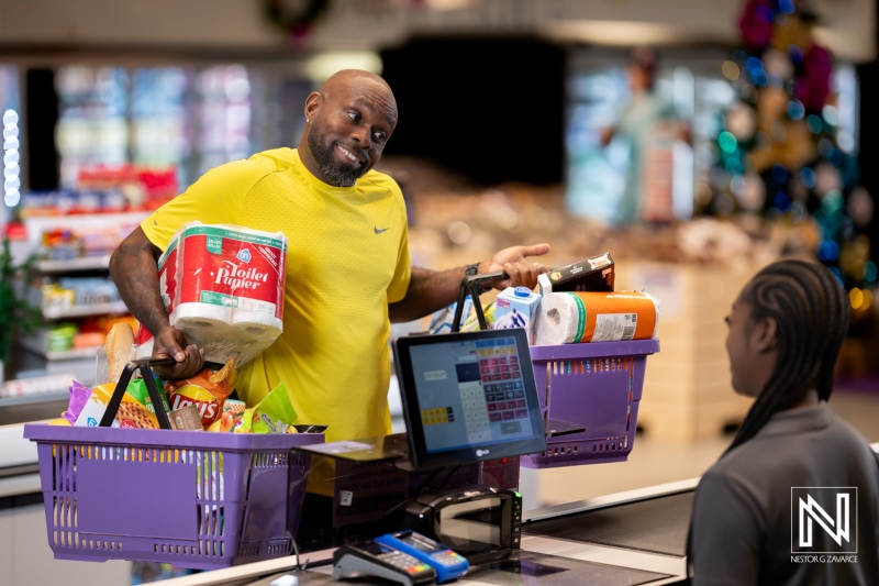 Branding photoshoot at Van den Tweel Supermarket in Curacao focusing on shopper and cashier interaction