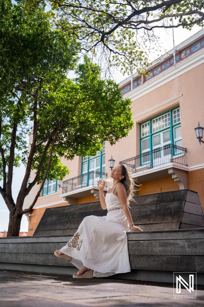 Product photoshoot for ParfumLab Curacao at a sunny outdoor location with a model holding perfume