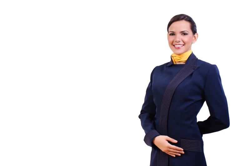 A Flight Attendant in a Navy Uniform Stands With a Welcoming Smile, Ready to Assist Passengers in an Airport Terminal During the Busy Travel Season