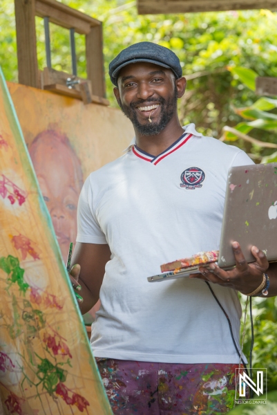 An Artist at Work in a Lush Garden, Using a Laptop for Inspiration While Painting a Vibrant Portrait of a Child During Daylight Hours