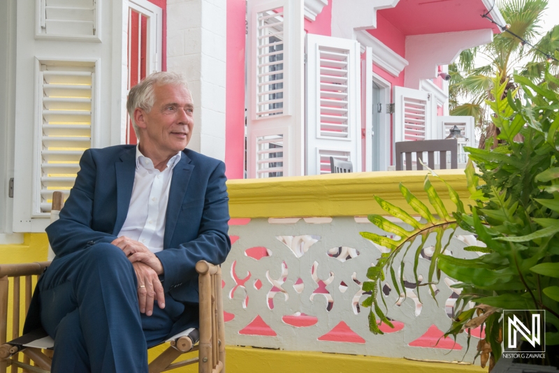 A Relaxed Gentleman Enjoying the View at a Colorful Tropical Resort During the Afternoon in a Charming Outdoor Setting