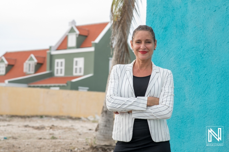 Confident Businesswoman Poses in Front of Colorful Buildings on a Sunny Day, Showcasing Architectural Beauty and Professionalism in an Outdoor Setting