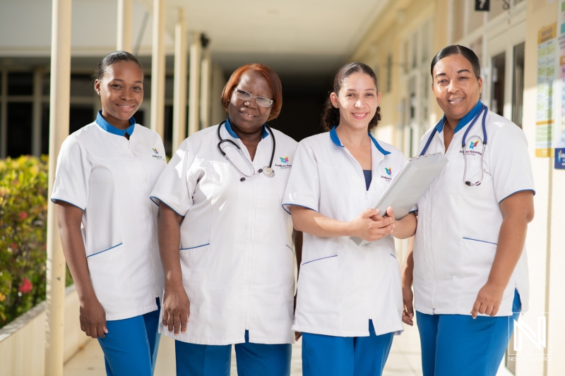 A Diverse Group of Healthcare Professionals Stands Together Outside a Medical Facility, Showcasing Teamwork and Dedication in Patient Care During Daylight Hours