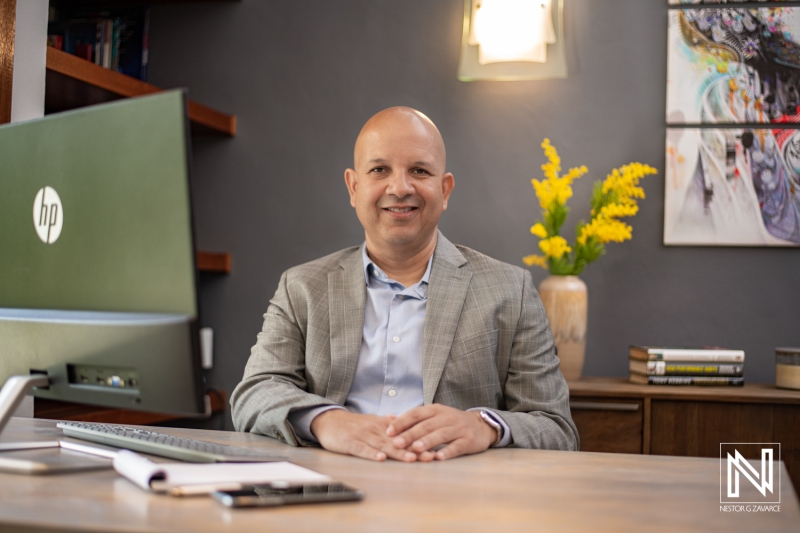 A Professional Individual Sits Confidently at a Modern Workstation, Surrounded by Stylish Decor, Emphasizing Productivity and a Contemporary Workspace Atmosphere