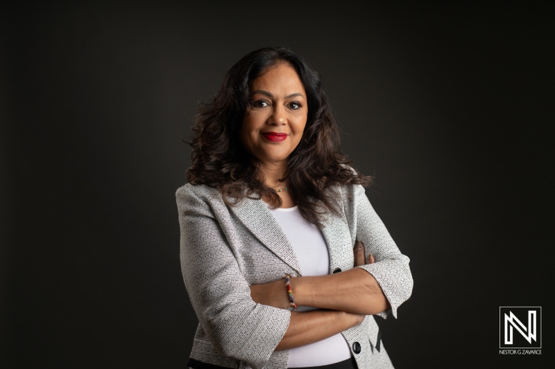 Confident Businesswoman Poses With Arms Crossed Against a Dark Background Showcasing Her Professionalism in a Corporate Setting