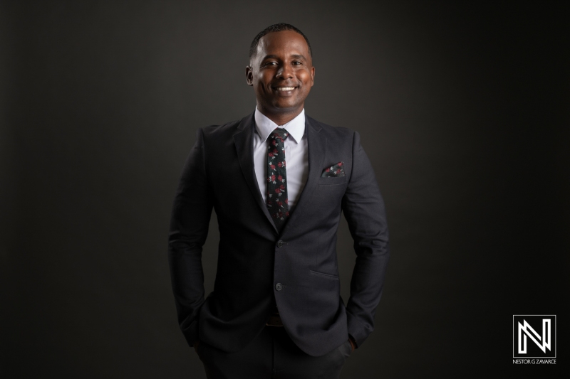 A Well-Dressed Man in a Tailored Suit Poses Confidently in a Professional Studio Setting, Showcasing a Keen Sense of Style and Poise During a Formal Photoshoot