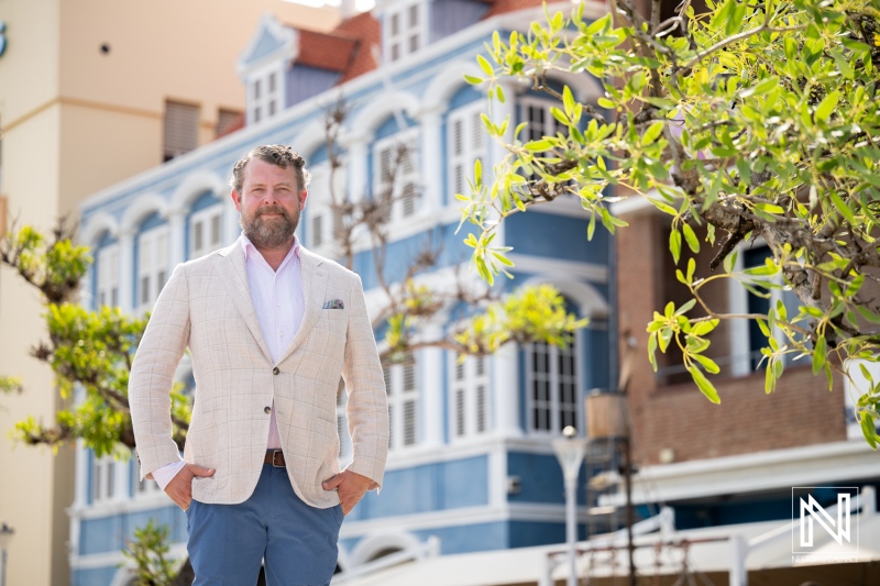 Corporate headshot taken in Curacao at a vibrant historic location during sunny weather