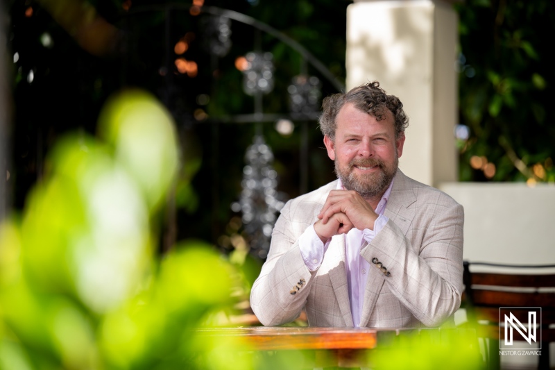 Professional corporate headshot taken in Curacao showcasing a confident individual in a relaxed outdoor setting