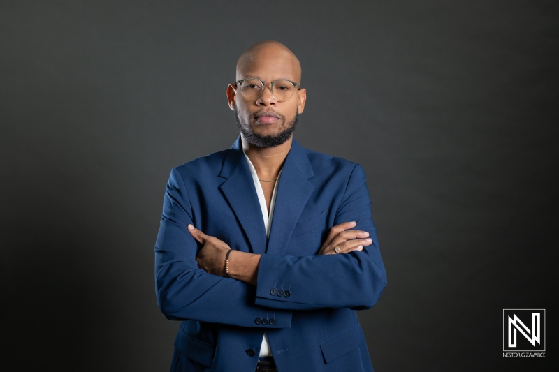 Corporate headshot of a business professional in Curacao with arms crossed and a focused expression