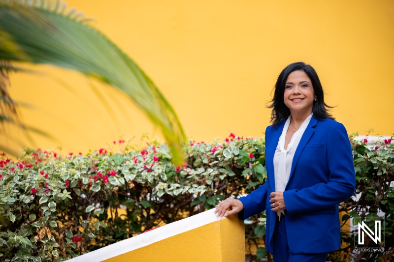 Professional corporate headshot in Curacao with bright backdrop and greenery