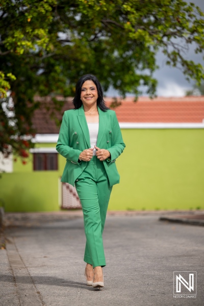 Corporate headshot taken in Curacao showing a person walking on the street in a green outfit