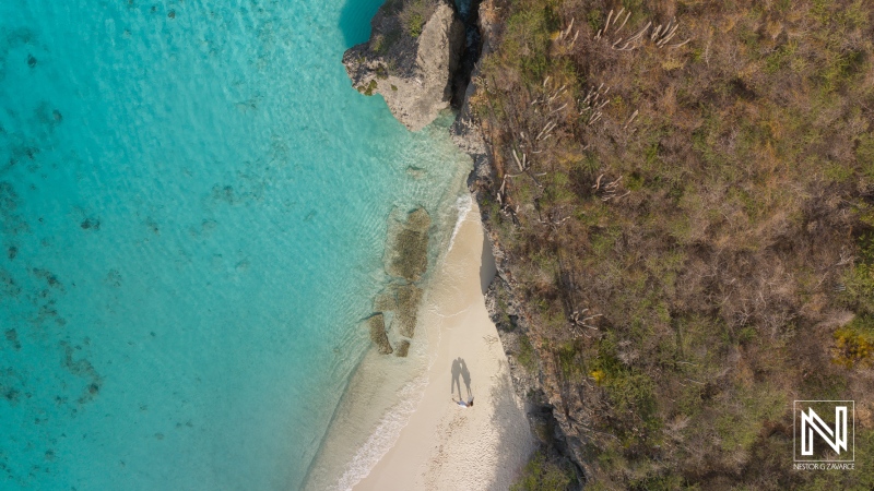 Couple enjoys a romantic sunrise photoshoot on the serene shores of Cas Abao Beach in Curacao