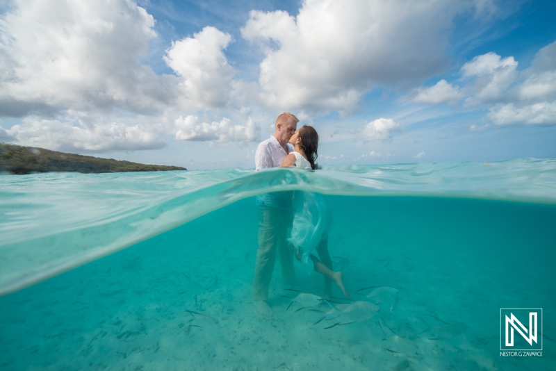 Couple enjoys a romantic sunrise embrace at Cas Abao Beach in Curacao’s clear waters