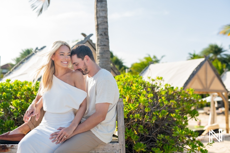Couple enjoying a romantic moment at Baoase Luxury Resort in Curacao under the warm sun amidst lush green surroundings