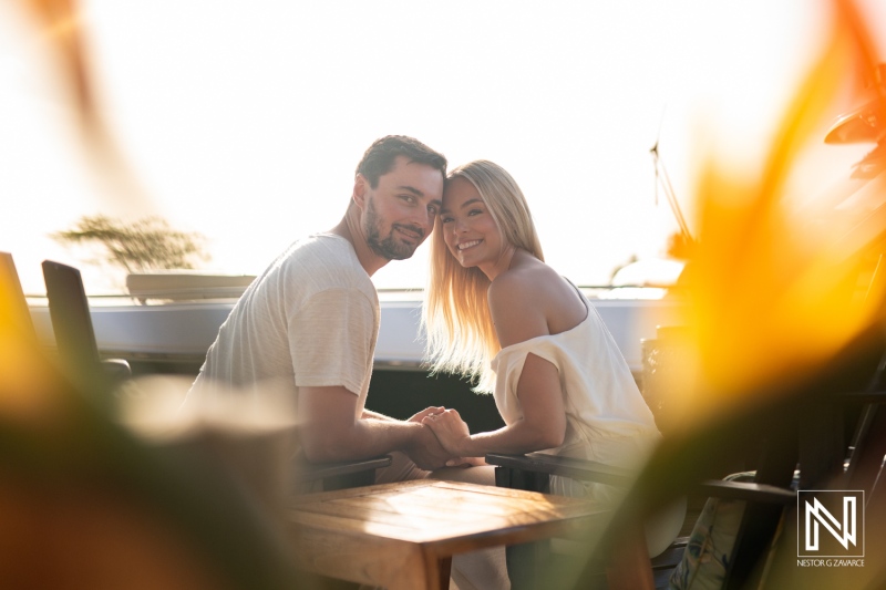 Couple enjoys a romantic moment at Baoase Luxury Resort in Curacao during a sunset, capturing a beautiful experience together