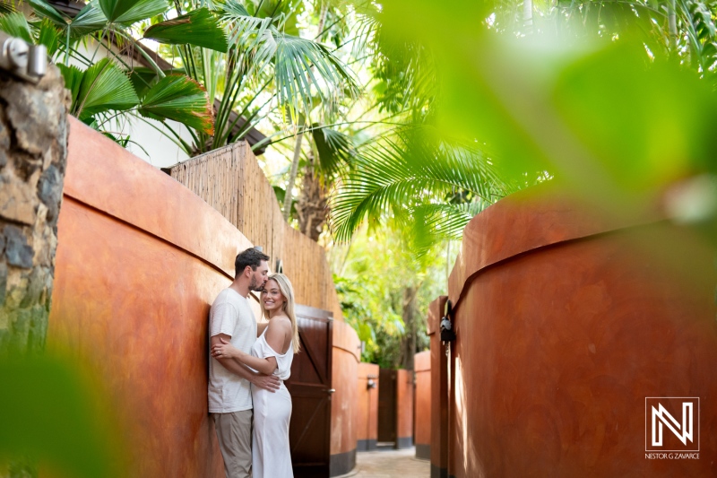 Couple enjoying a romantic moment at Baoase Luxury Resort in Curacao surrounded by lush tropical greenery