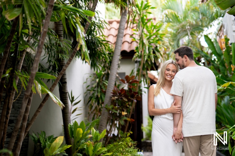 Couple enjoying a romantic moment at Baoase Luxury Resort in Curacao surrounded by lush tropical greenery