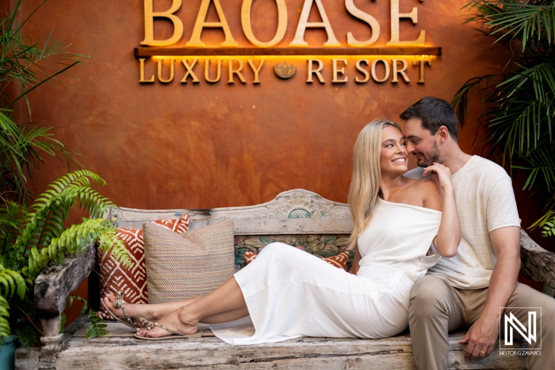 Couple enjoying a romantic moment on a bench at Baoase Luxury Resort in Curacao during a sunny day