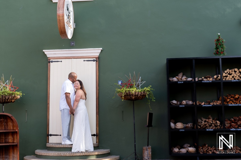 Couple enjoying a romantic moment in Curacao outside a charming venue with rustic decor