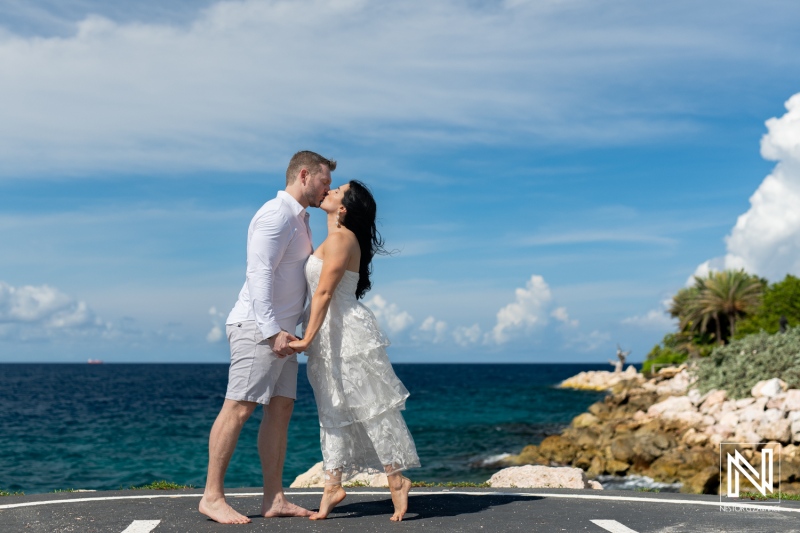 Couple enjoys a romantic moment at Baoase Luxury Resort in Curacao during a beautiful sunny day by the ocean