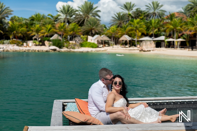 Couple enjoying a romantic moment at Baoase Luxury Resort in Curacao overlooking the serene lagoon