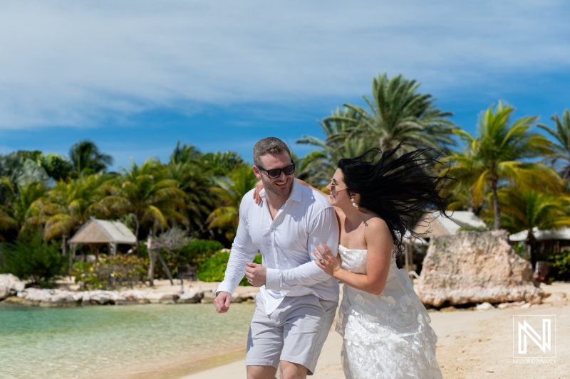 Couple enjoying a romantic moment at Baoase Luxury Resort in Curacao during a sunny day at the beach