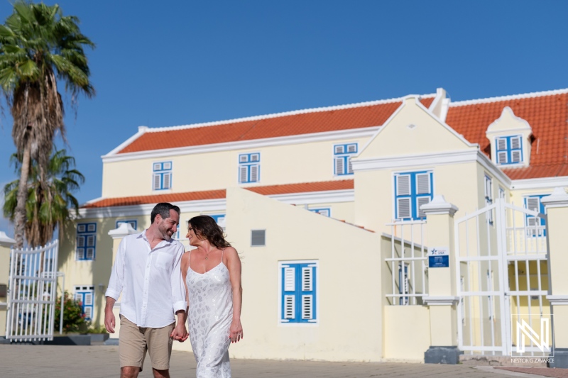 Couple enjoys a romantic stroll on Otrobanda in Curacao, surrounded by stunning scenery and architectural beauty