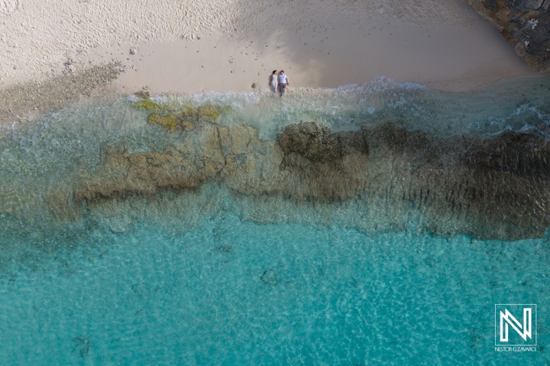Couple enjoying a romantic moment at Cas Abao Beach in Curacao under the clear sky and pristine waters