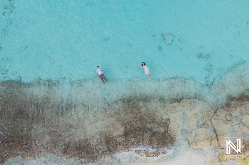 Couple enjoying tranquility while floating in the clear turquoise waters of Cas Abao Beach in Curacao