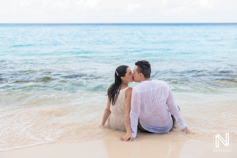 Couple enjoys a romantic moment on Cas Abao Beach in Curacao while relaxing in the tranquil water