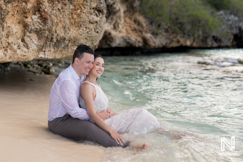Couple enjoys a romantic moment at Cas Abao Beach in Curacao during a serene afternoon by the water