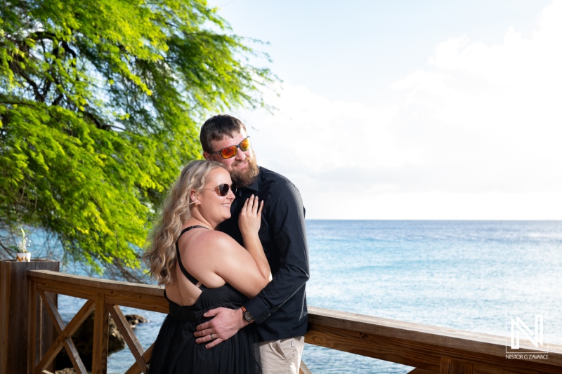 Couple enjoys a romantic moment by the sea in Curacao during a sunny day