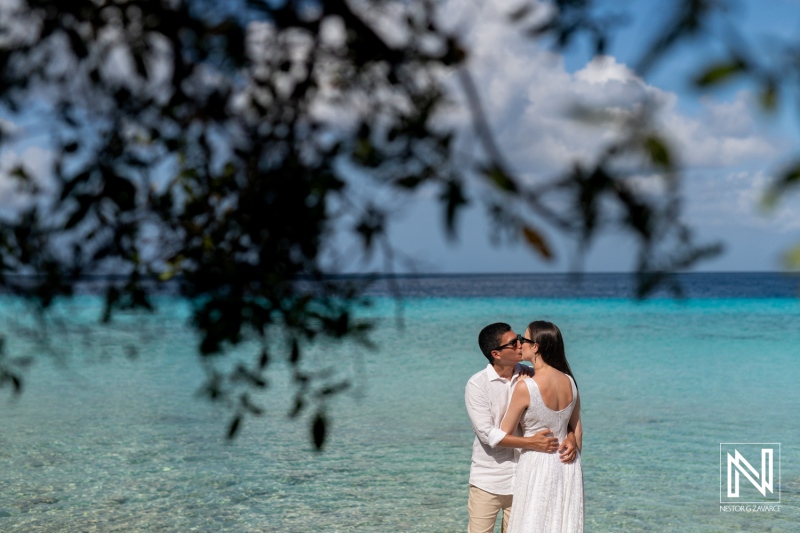 Couple enjoys a romantic sunrise photoshoot at Playa Porto Mari in Curacao, capturing the beauty of love against a stunning ocean backdrop