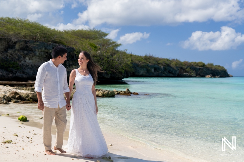 Couple enjoy a romantic sunrise stroll on the tranquil shores of Playa Porto Mari in Curacao
