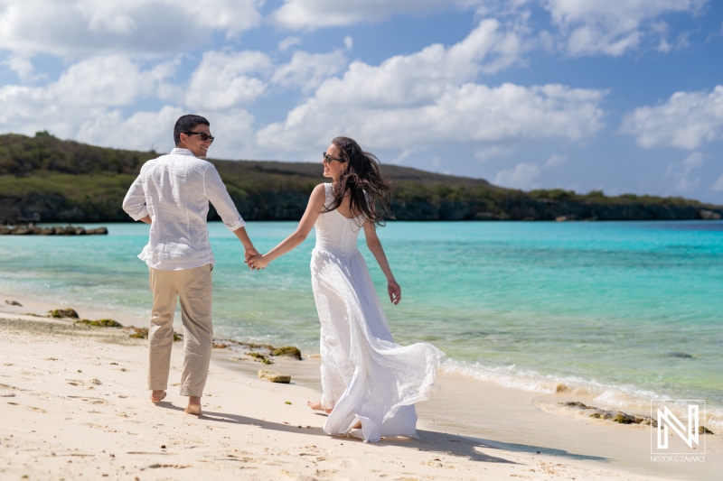 Couple enjoys a romantic photoshoot at sunrise on the serene shores of Playa Porto Mari in Curacao