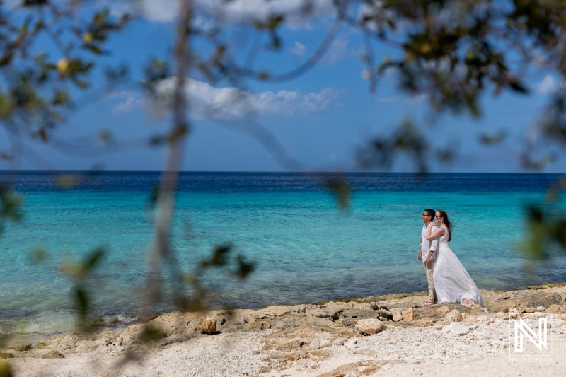 Couple enjoys romantic sunrise photoshoot at Playa Porto Mari in Curacao, capturing love against a stunning Caribbean backdrop