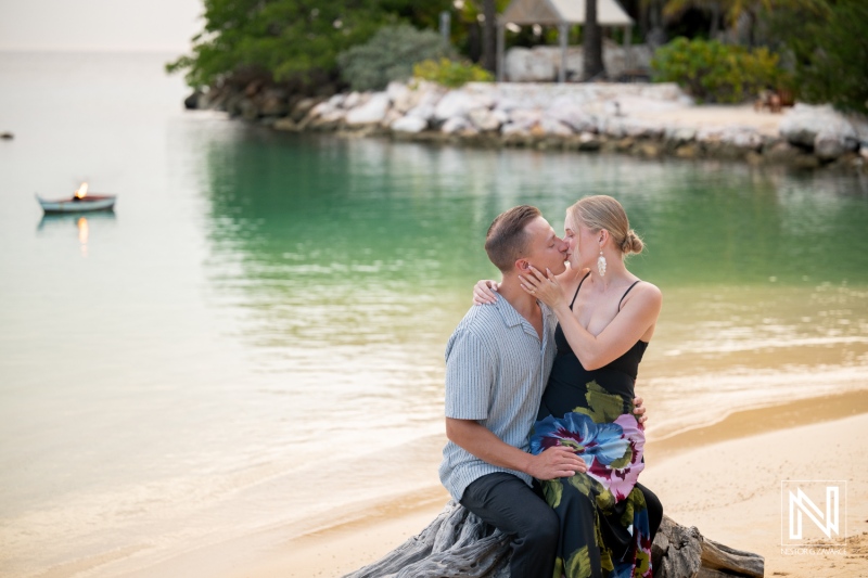 Couple enjoys a romantic moment during a photoshoot at Baoase Luxury Resort in Curacao by the beach at sunset