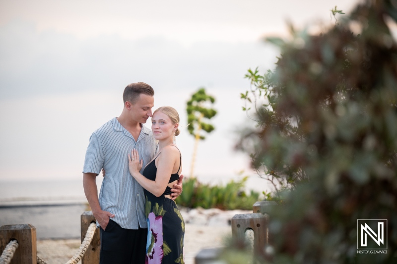 Couple enjoys moments together during photoshoot at Baoase Luxury Resort in Curacao near the beach at sunset