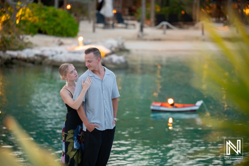 Couple enjoys a photoshoot at Baoase Luxury Resort in Curacao during sunset near the water's edge
