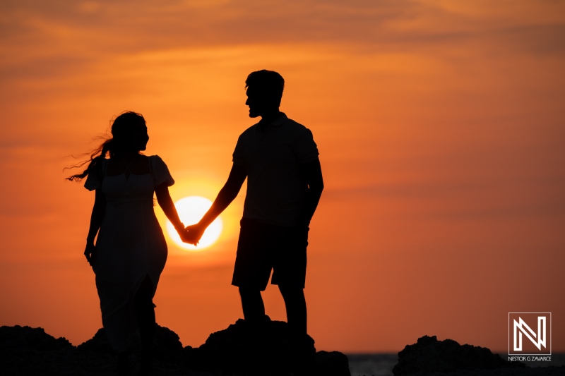 Engagement session at sunset in St. Michiel, Curacao, capturing a romantic moment between a couple on the shoreline of Boka Sami