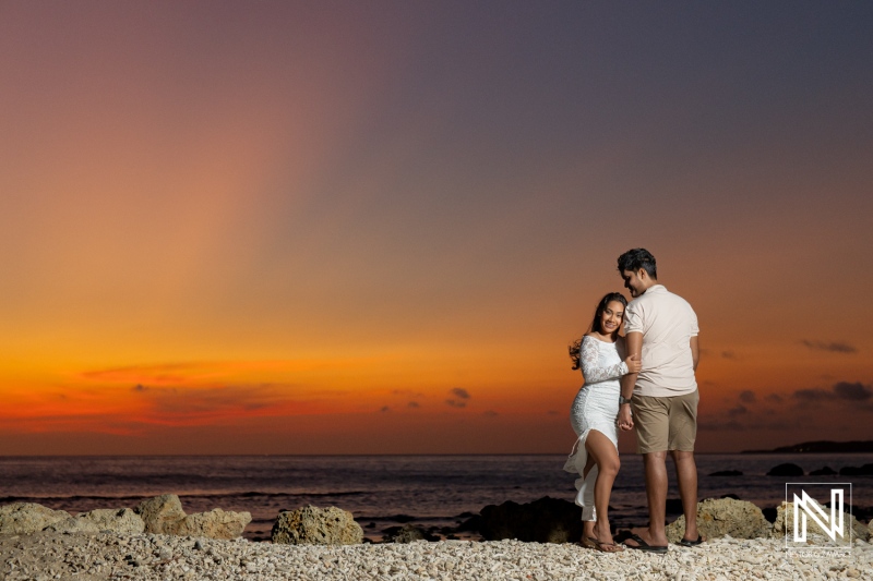 Engagement session capturing love at sunset in St. Michiel, Curacao with a stunning Boka Sami backdrop