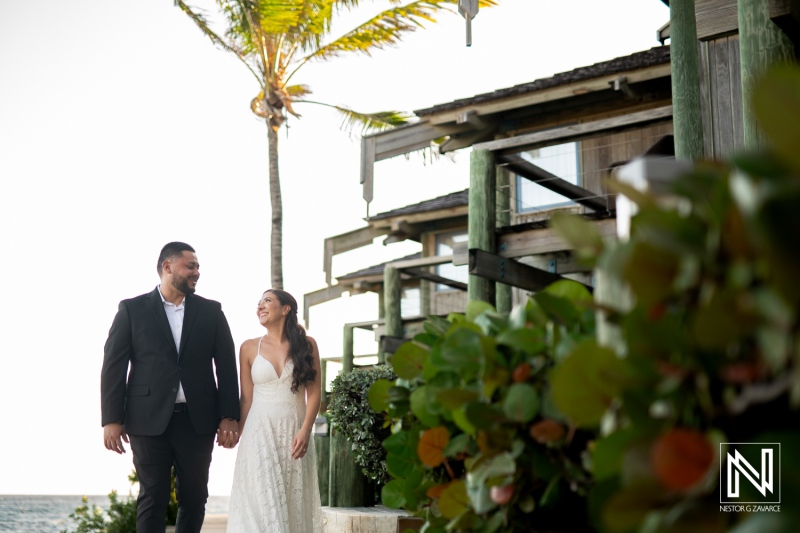 Engagement celebration on the beautiful shores of Curacao with a joyful couple walking hand in hand during sunset