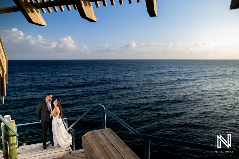 Engagement celebration at sunset on the coast of Curacao with a couple enjoying the ocean view