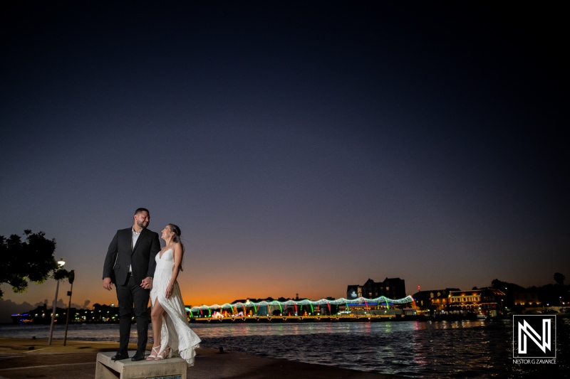 Engagement celebration at sunset in Curacao with elegant couple by the waterfront