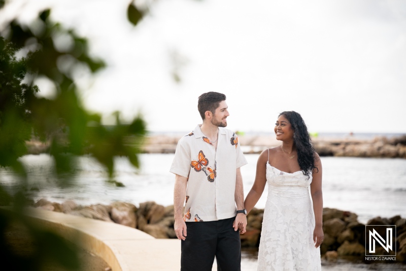 Couple enjoys engagement session at Marie Pampoen in Curacao during a sunny day by the water