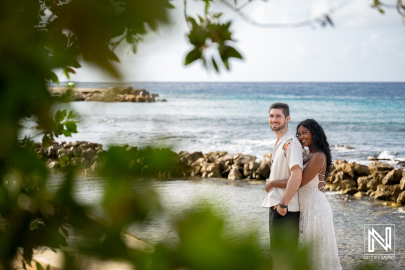 Engagement session at Marie Pampoen in Curacao with couple near water and rocks during sunny day