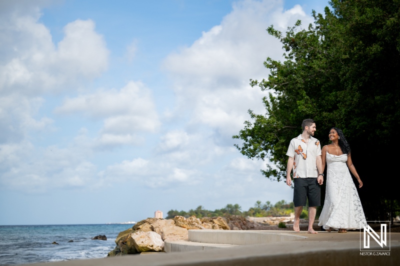 Couple enjoys engagement session while walking along the shore at Marie Pampoen in Curacao during a sunny day