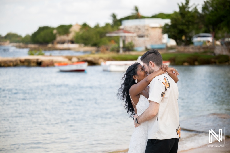Couple enjoys engagement session at Marie Pampoen in Curacao during a sunny day by the water