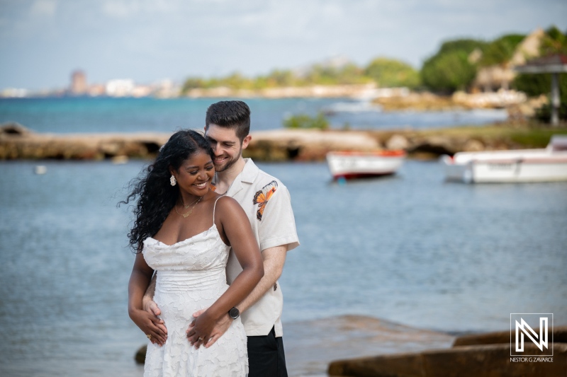 Couple enjoys engagement session at Marie Pampoen in Curacao with ocean in background during sunny day