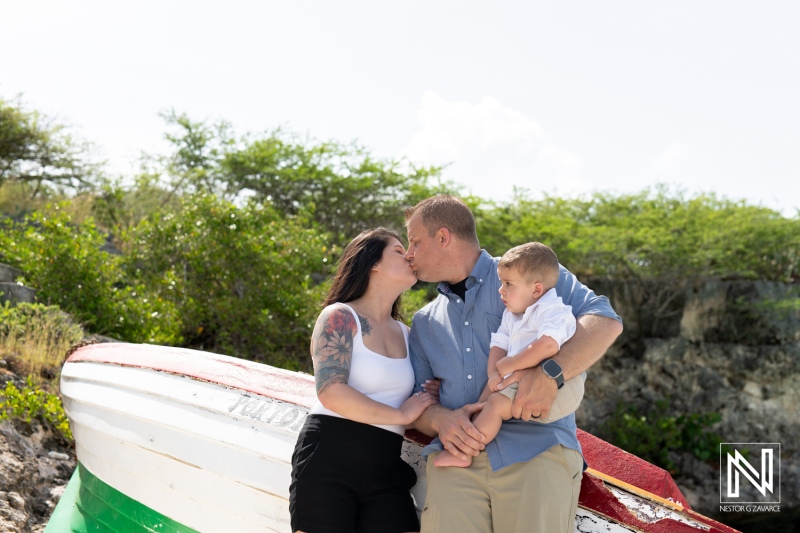 Family enjoying a joyful moment at the beach in Curacao while embracing the sunny weather